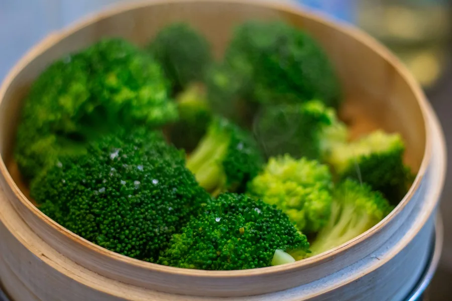 Broccoli florets in a steamer basket