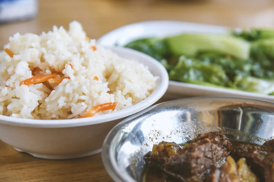 A bowl of rice served alongside other dishes