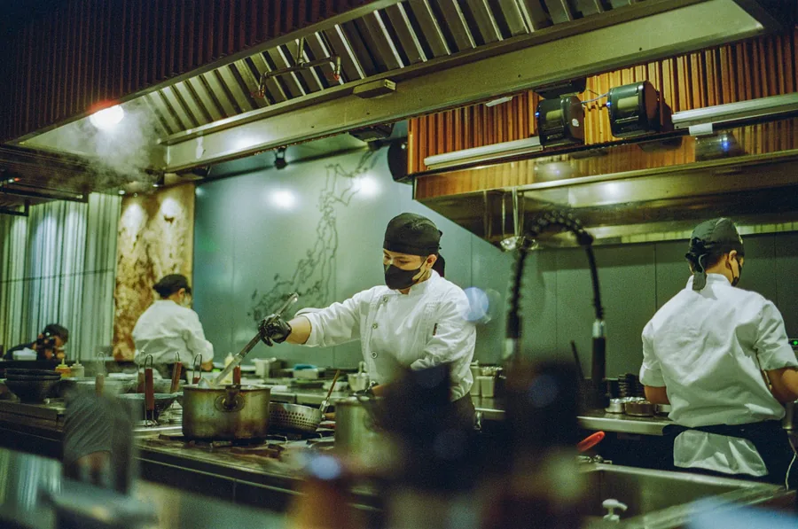 Cooks working a busy restaurant kitchen line