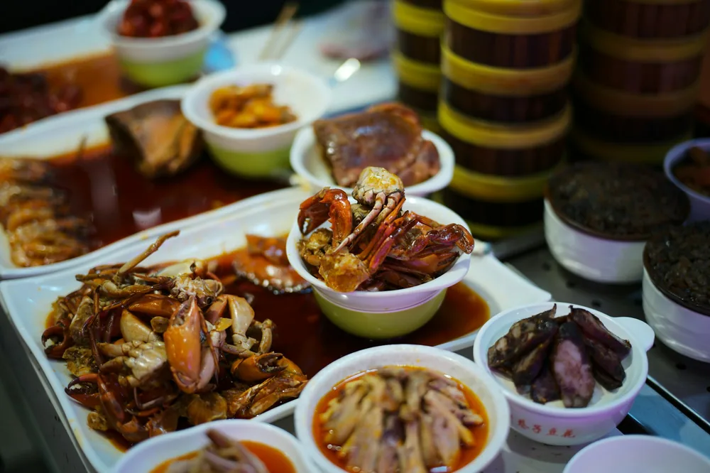 Many prepared dishes lined up in a kitchen