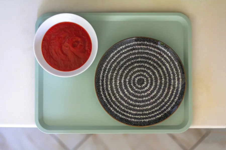 A small dish of sauce served on the side