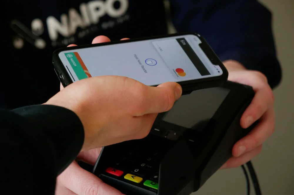 A card terminal held out to a customer