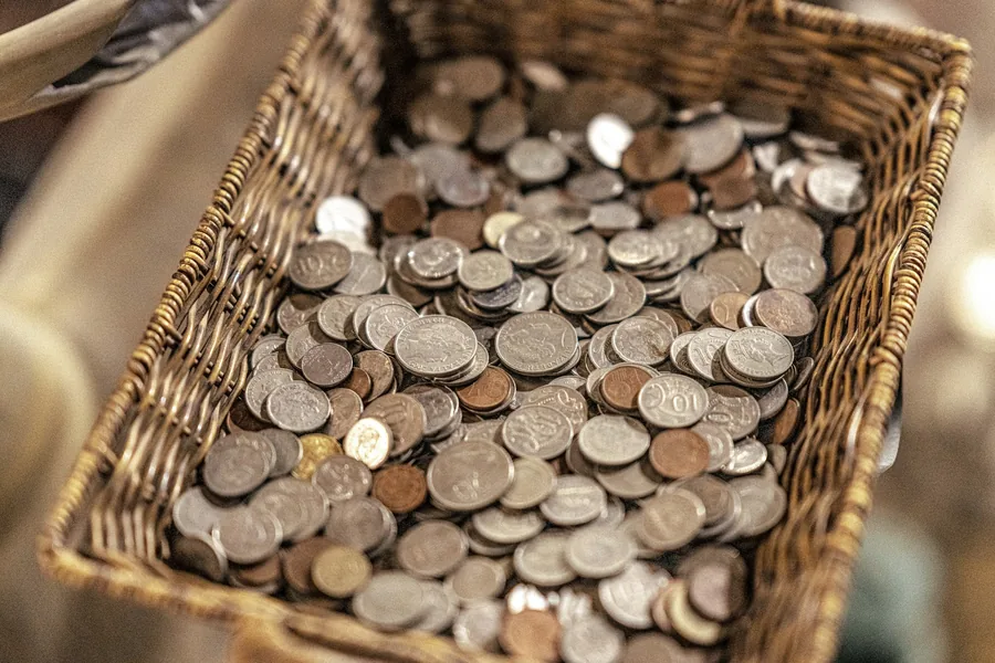 Coins collected in a small basket