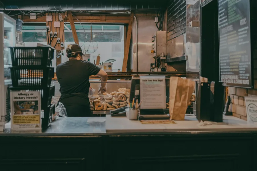A worker behind a takeaway counter