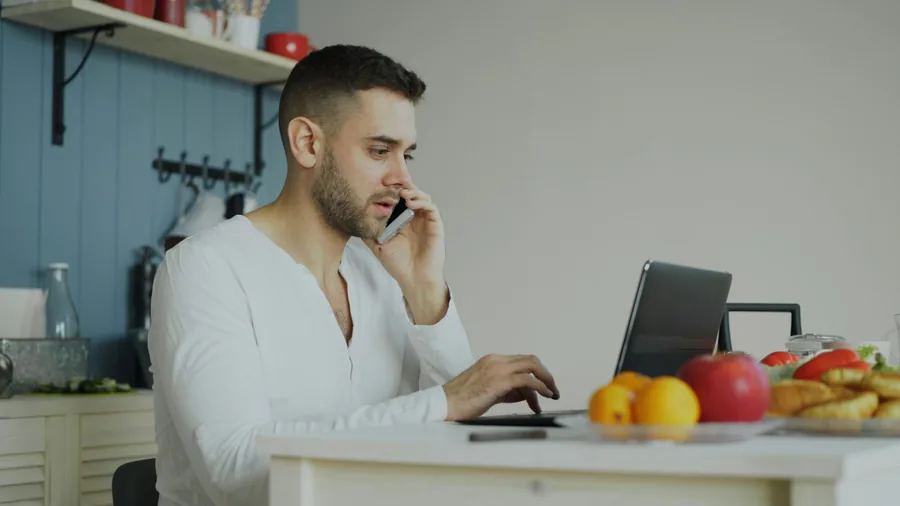 Someone making a phone call in a kitchen
