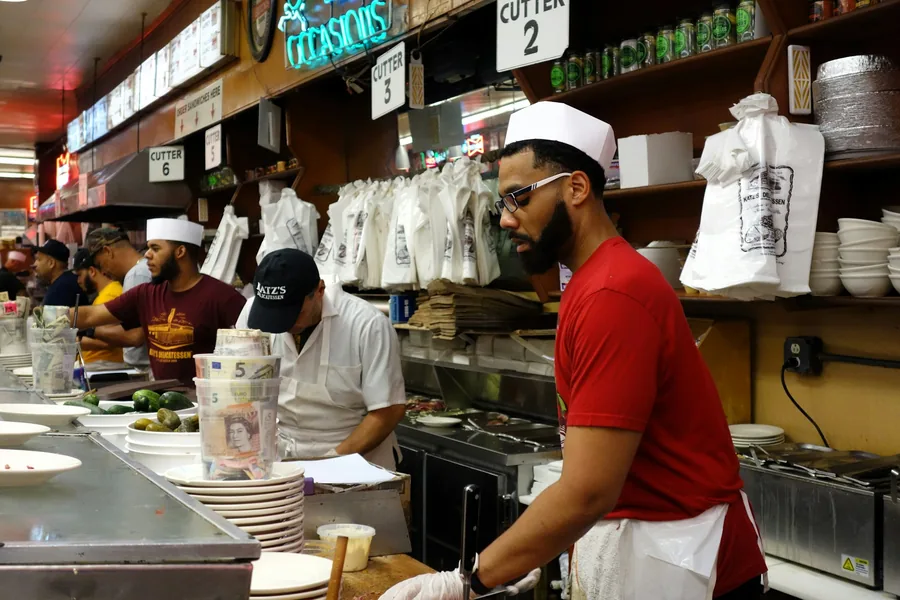 A busy food counter with staff serving