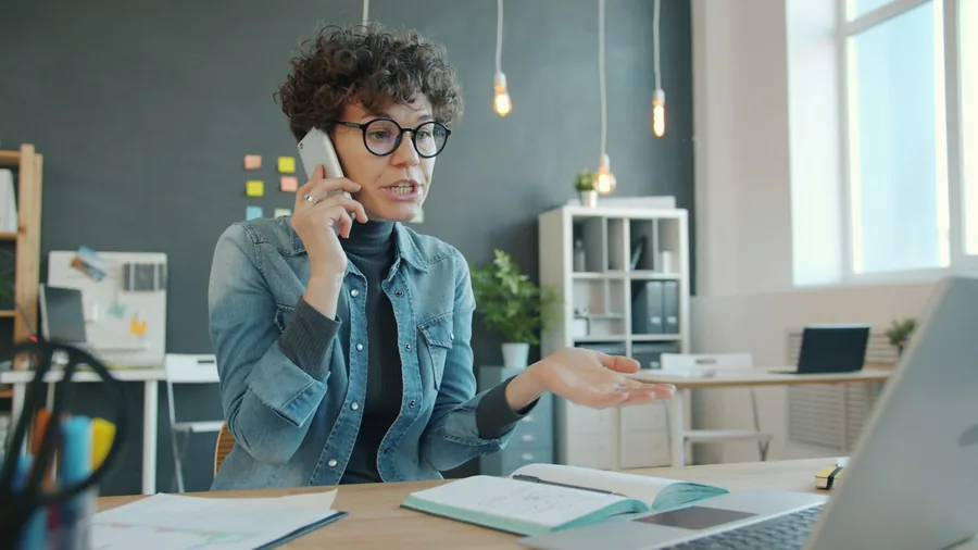 Someone making arrangements by phone at a desk