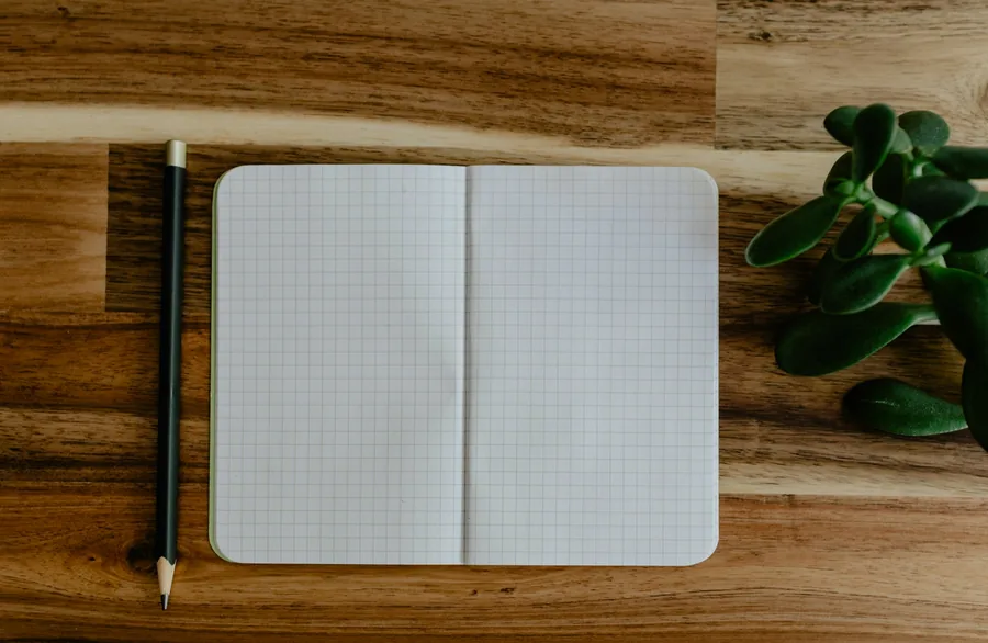 An open notebook and pencil on a table