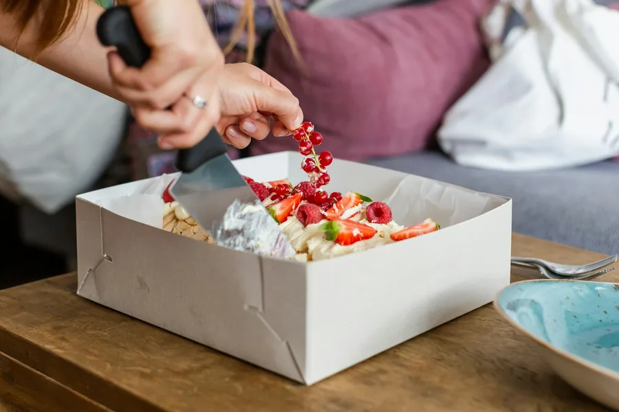 A coated paper food carton on a table