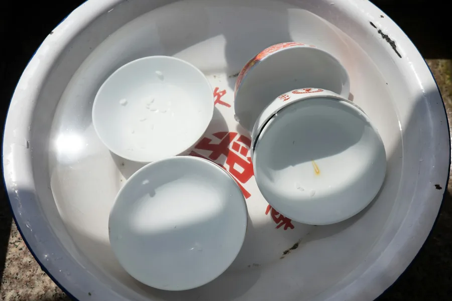Used disposable food containers in a bin