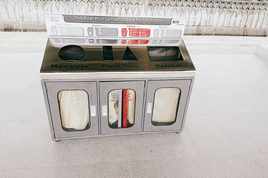 A recycling station with a food box on top