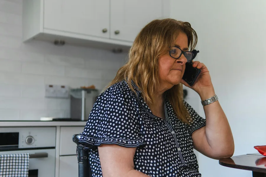 Someone making a phone call from home
