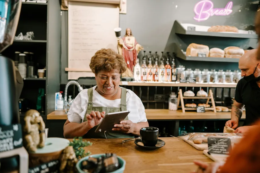 A customer choosing from a menu at a counter