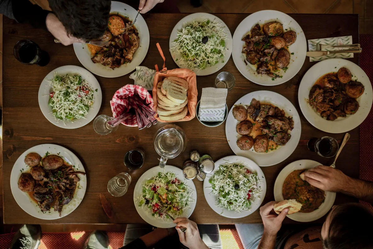 A large group sharing a meal around one table