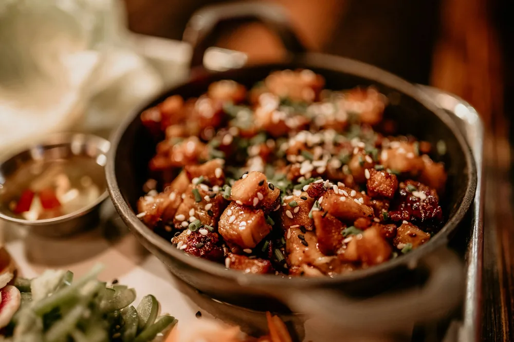 Glazed chicken pieces cooked in a pan