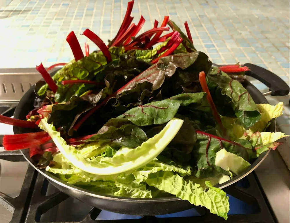 Mixed vegetables stir frying in a wok