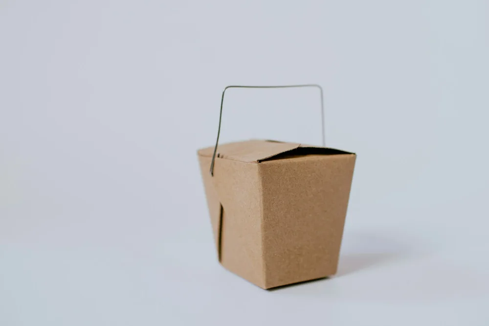A folded takeout carton of the kind noodles are packed in