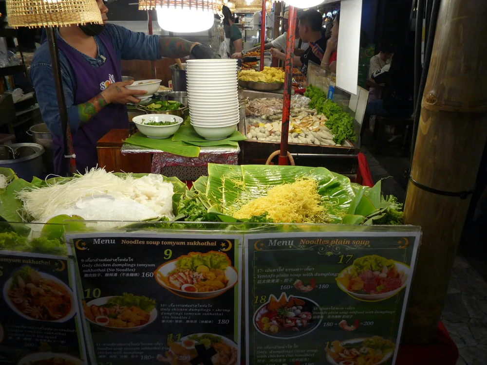 A market stall showing several kinds of fresh noodles
