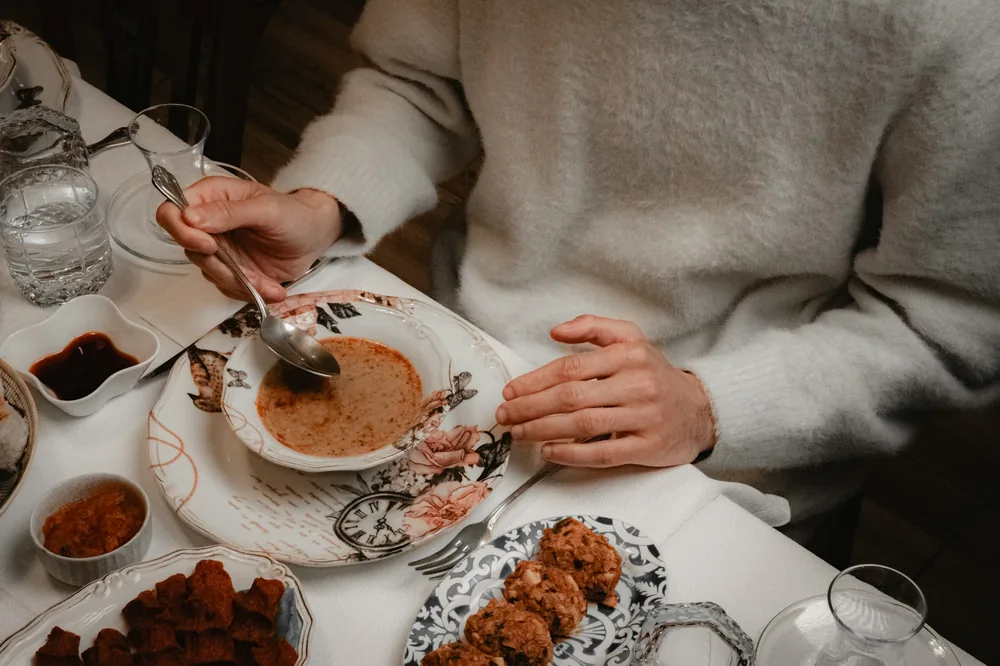 Food being served from a shared dish onto a plate