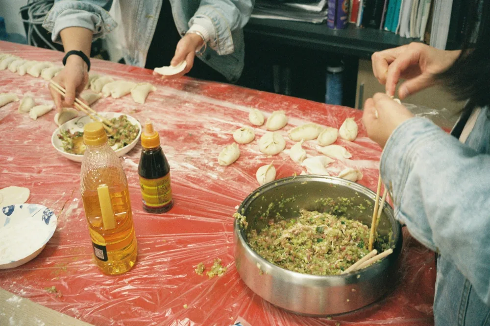 A cook plating a dish in a restaurant kitchen