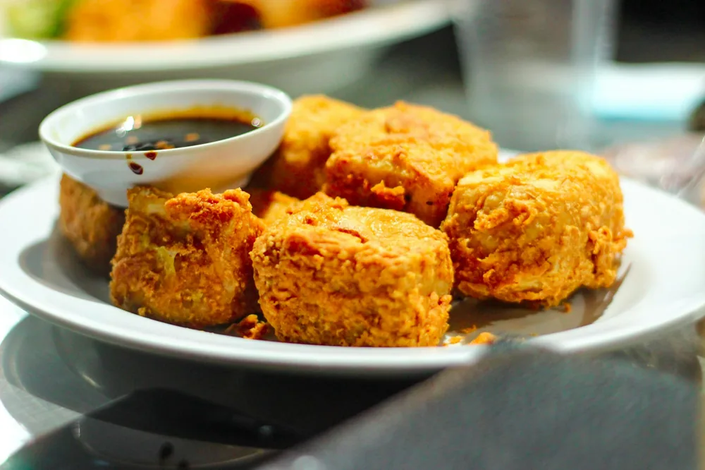 Crisp fried tofu cubes on a plate