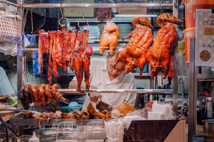 Roast meats hanging in a Chinese barbecue shop window