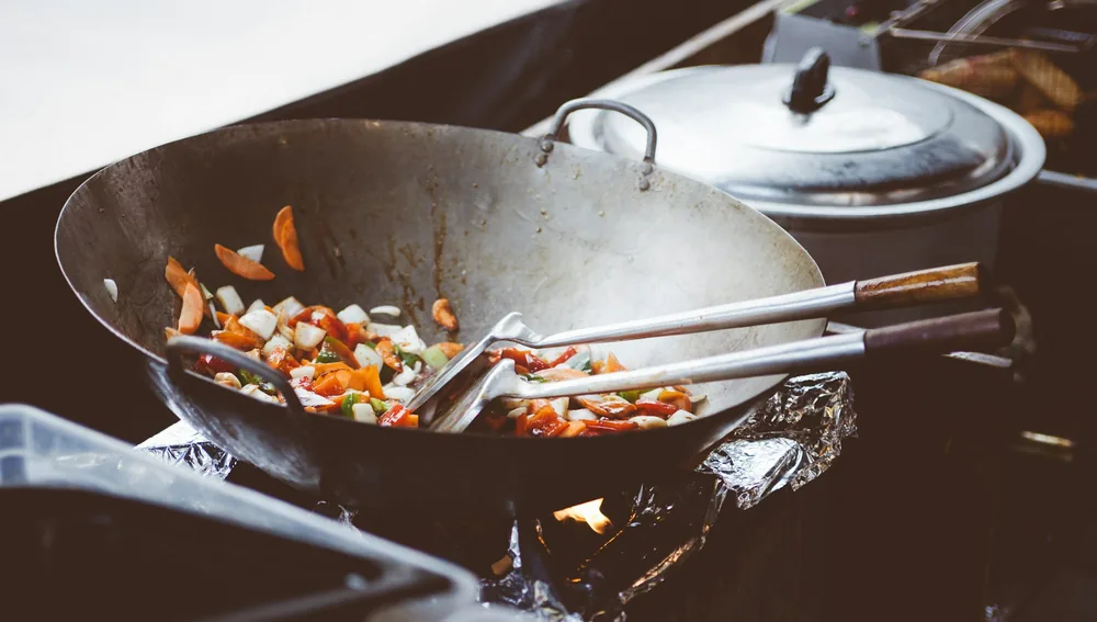 Several proteins cooking together in one wok
