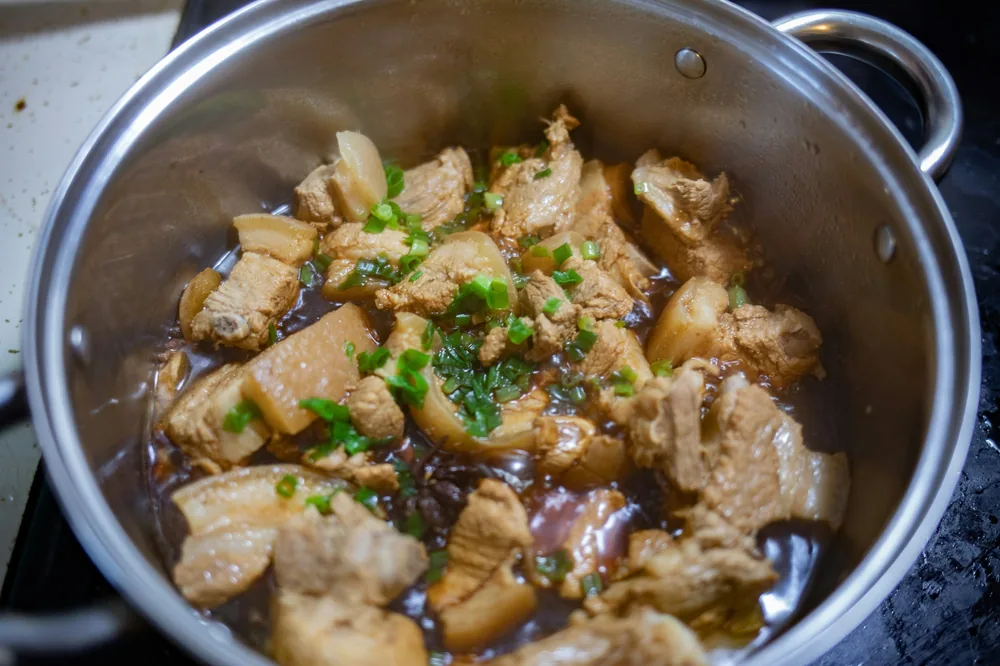 Twice cooked pork simmering in a pot