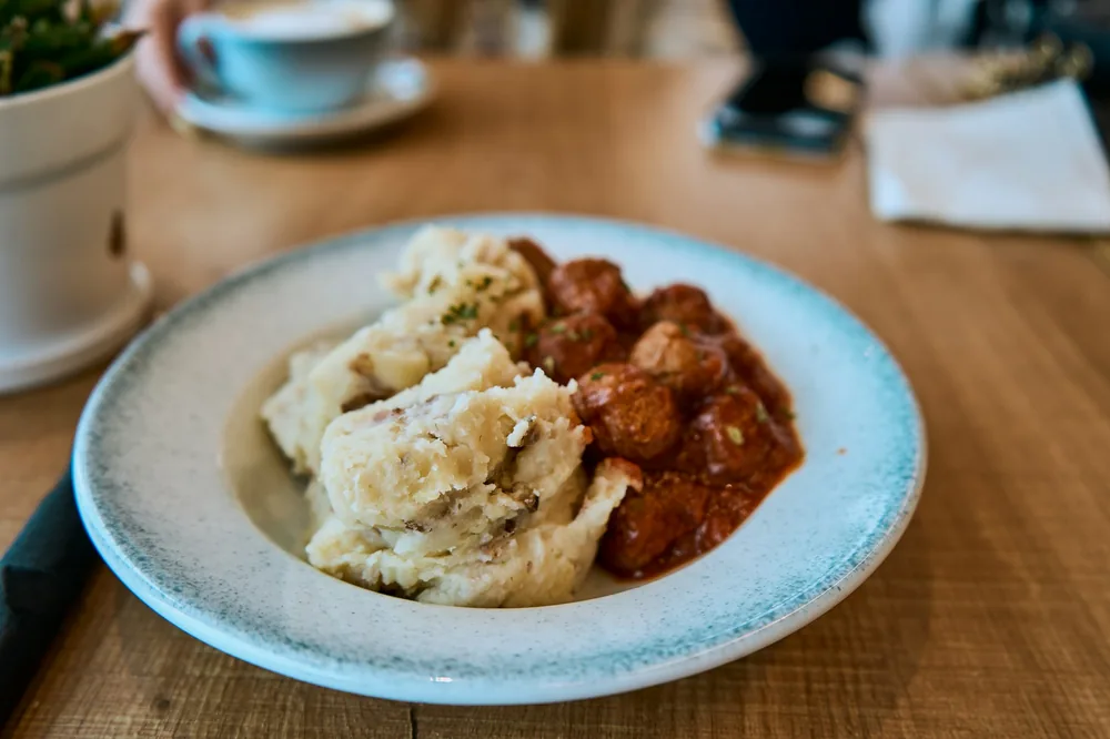 An egg patty served with gravy and rice