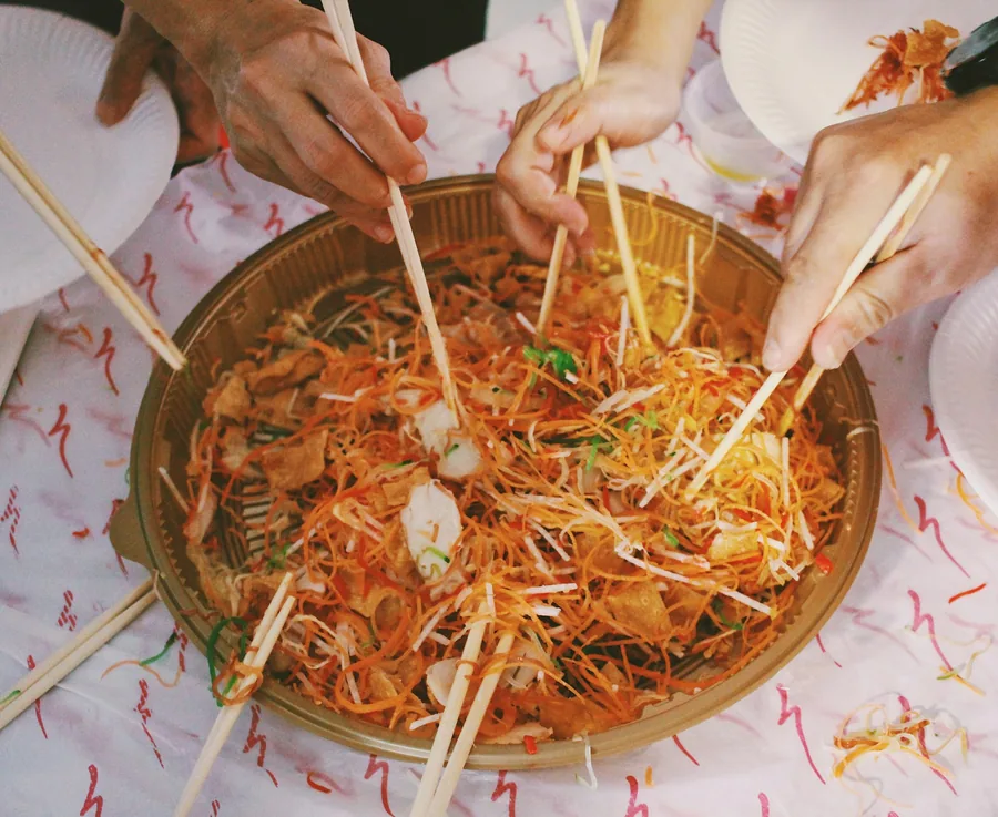 A large shared dish being served to several people