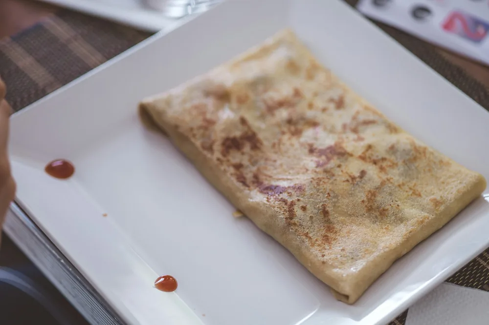 A thin pancake folded around a stir fried filling