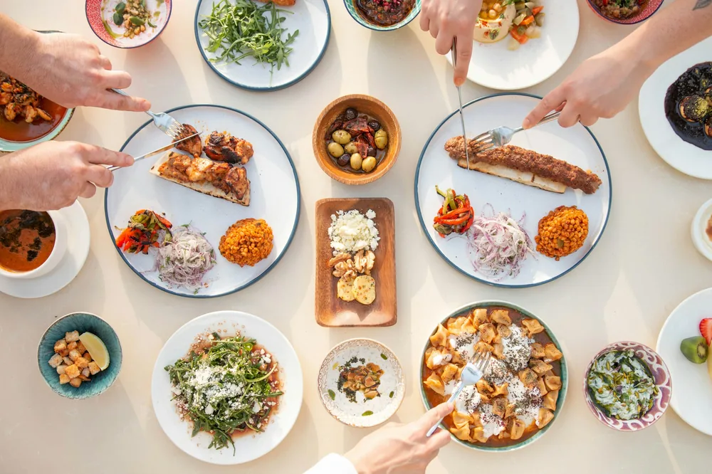Friends sharing several plates at a restaurant