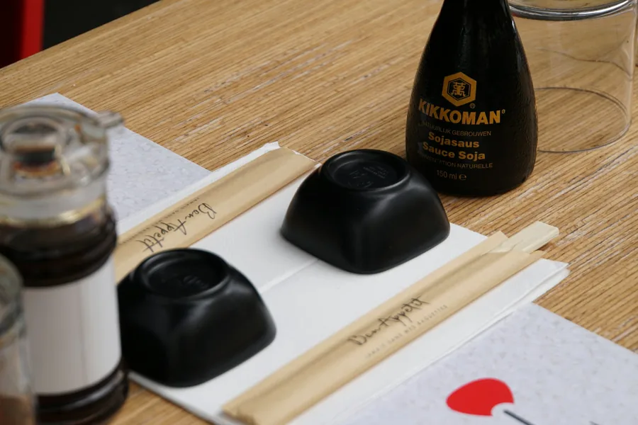A place setting with chopsticks and soy sauce