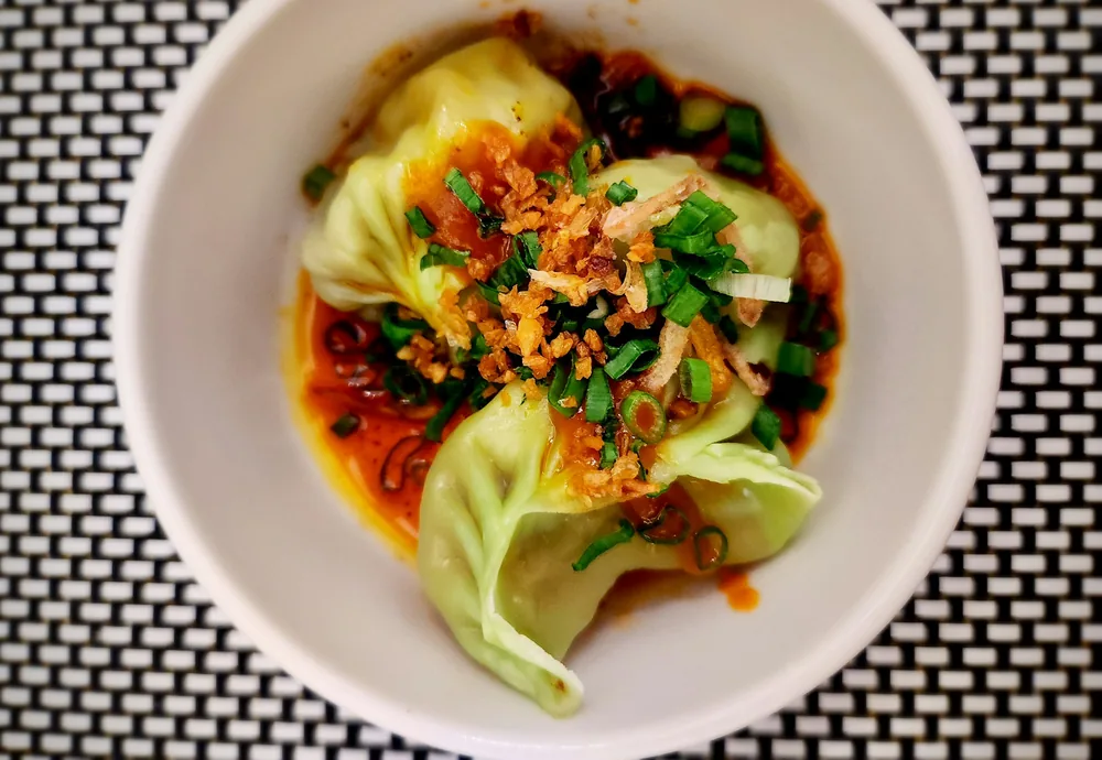 Dumplings served in a chilli oil sauce