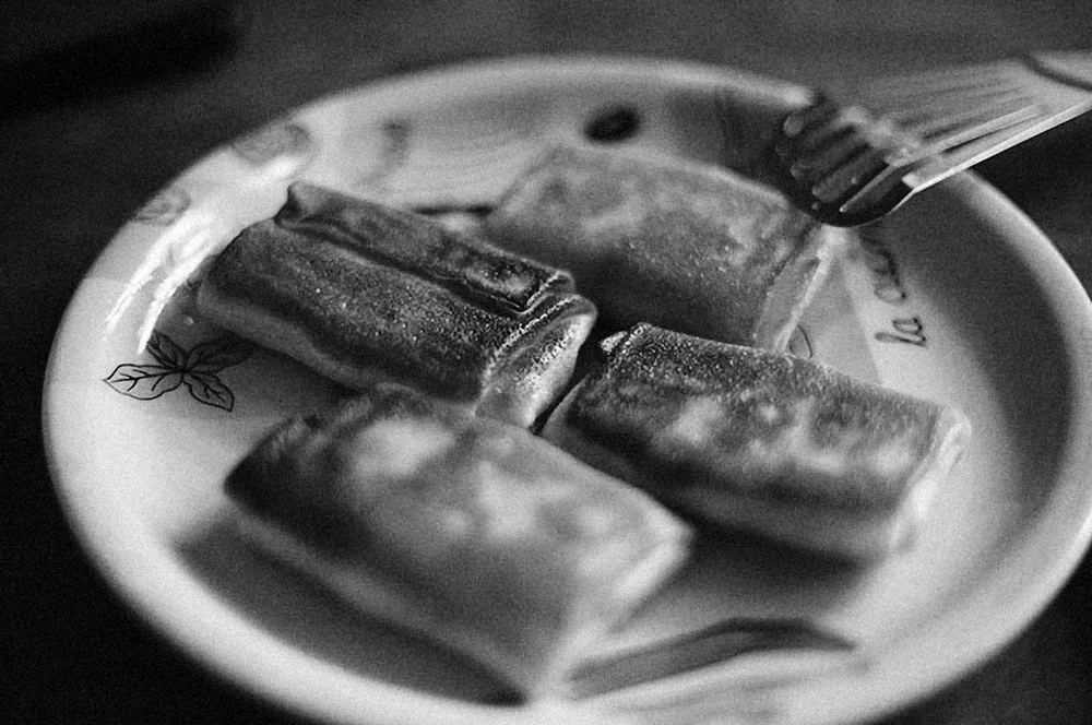 Fried rolls halved to show the filling