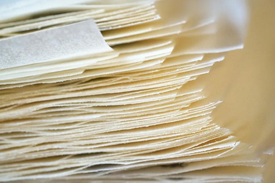 A stack of thin square wonton wrappers