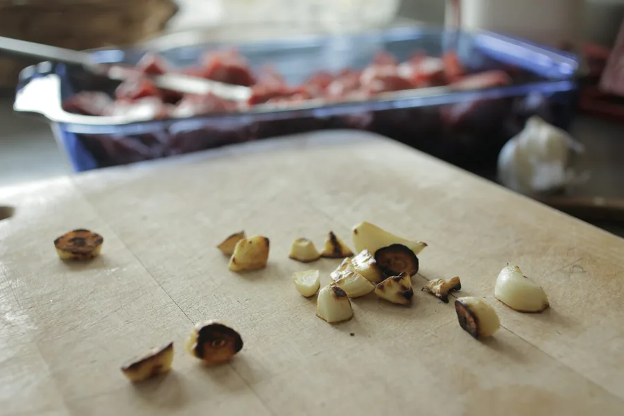 Garlic cloves chopped on a board