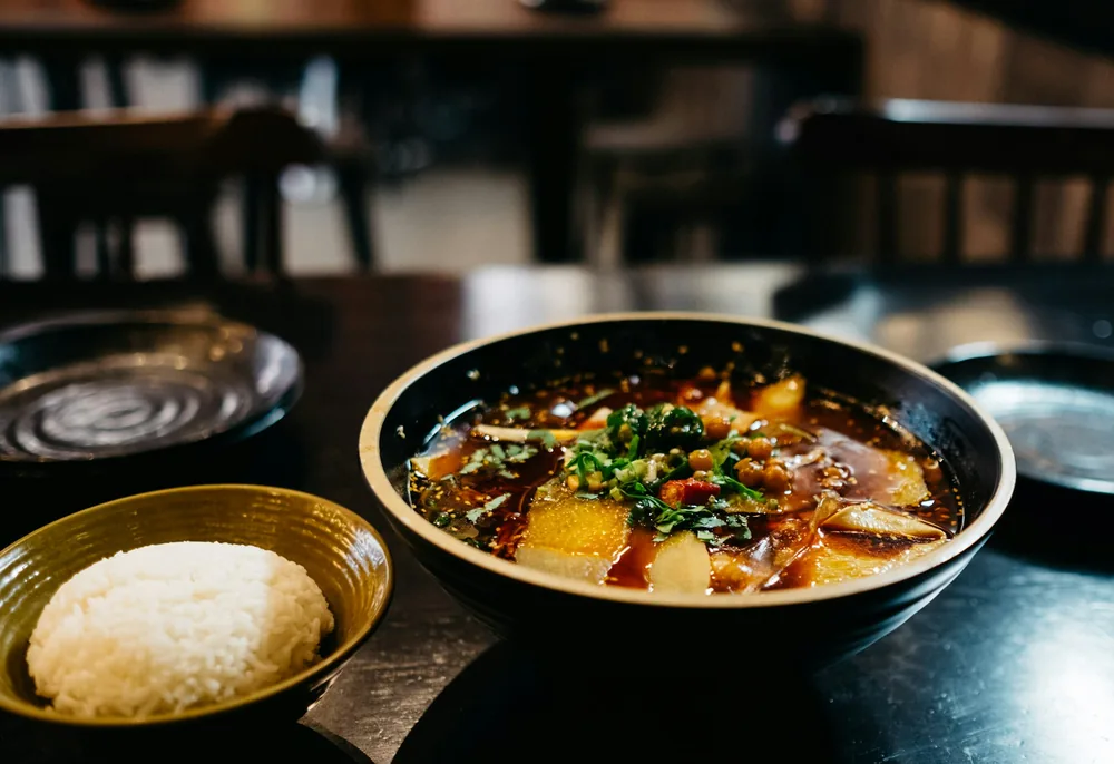 Dark, thickened hot and sour style soup in a bowl