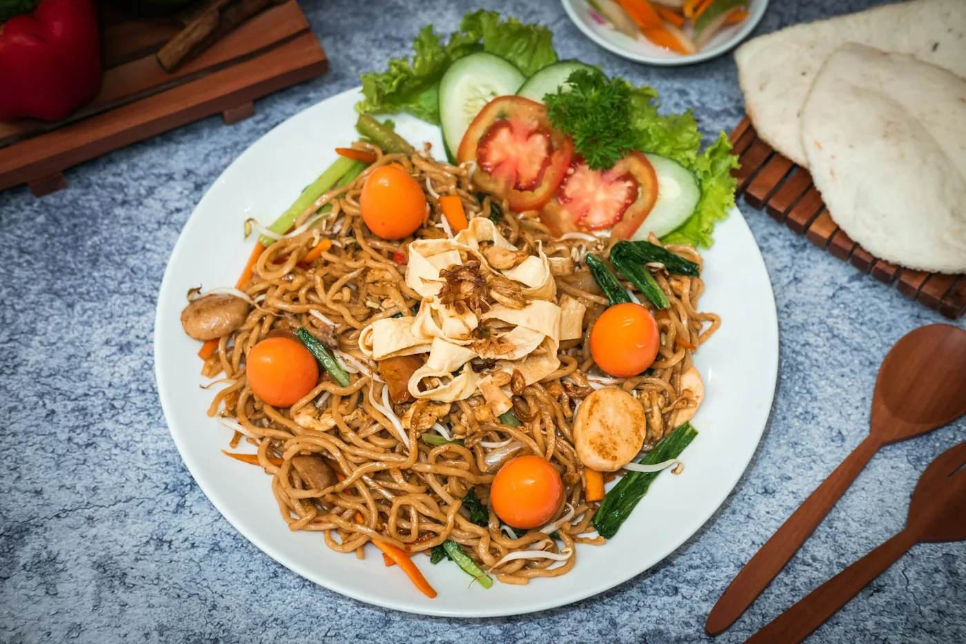 Thin rice noodles stir fried with vegetables on a plate