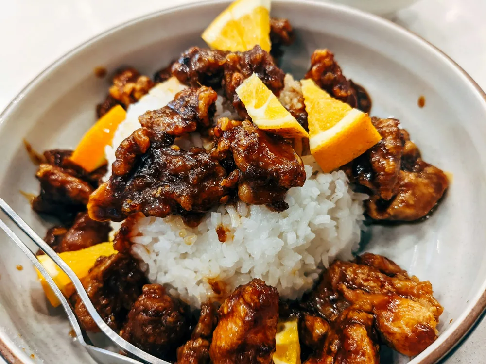 Crisp chicken in a glossy orange glaze with rice