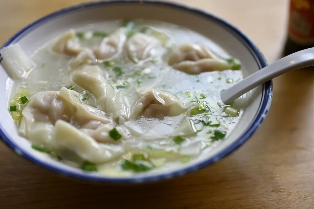 Wonton dumplings floating in a clear broth