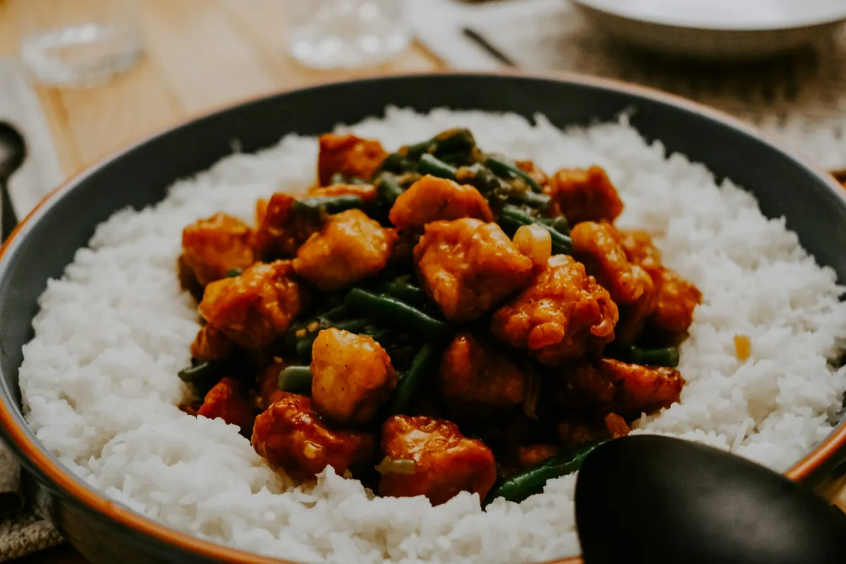 Glazed chicken pieces served over white rice