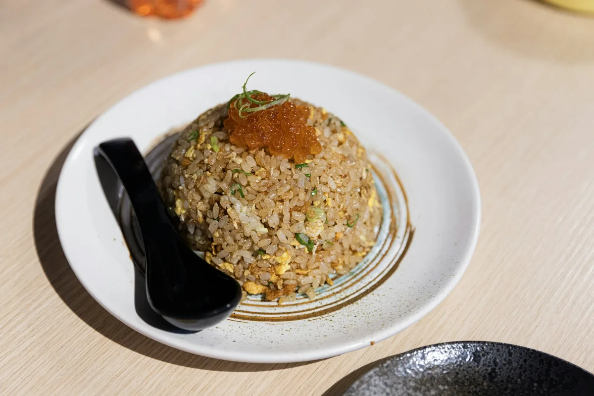 A serving of fried rice with a spoon alongside