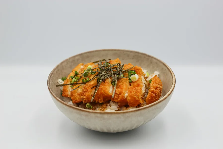 Glazed bourbon-style chicken served over rice in a bowl