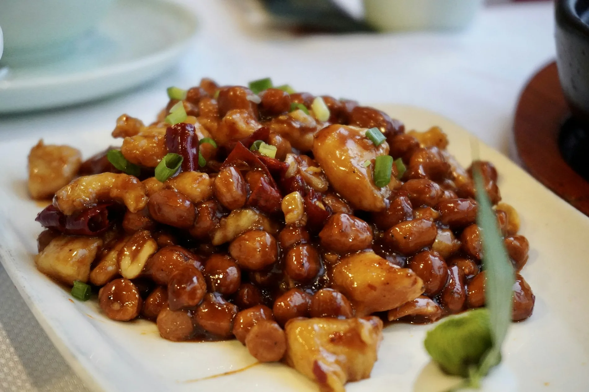 Glossy wok-fried Chinese chicken entree served on a platter