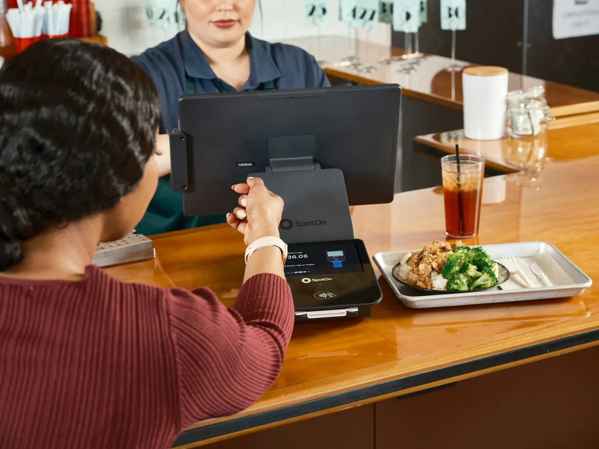 A customer paying for an order at a takeaway counter