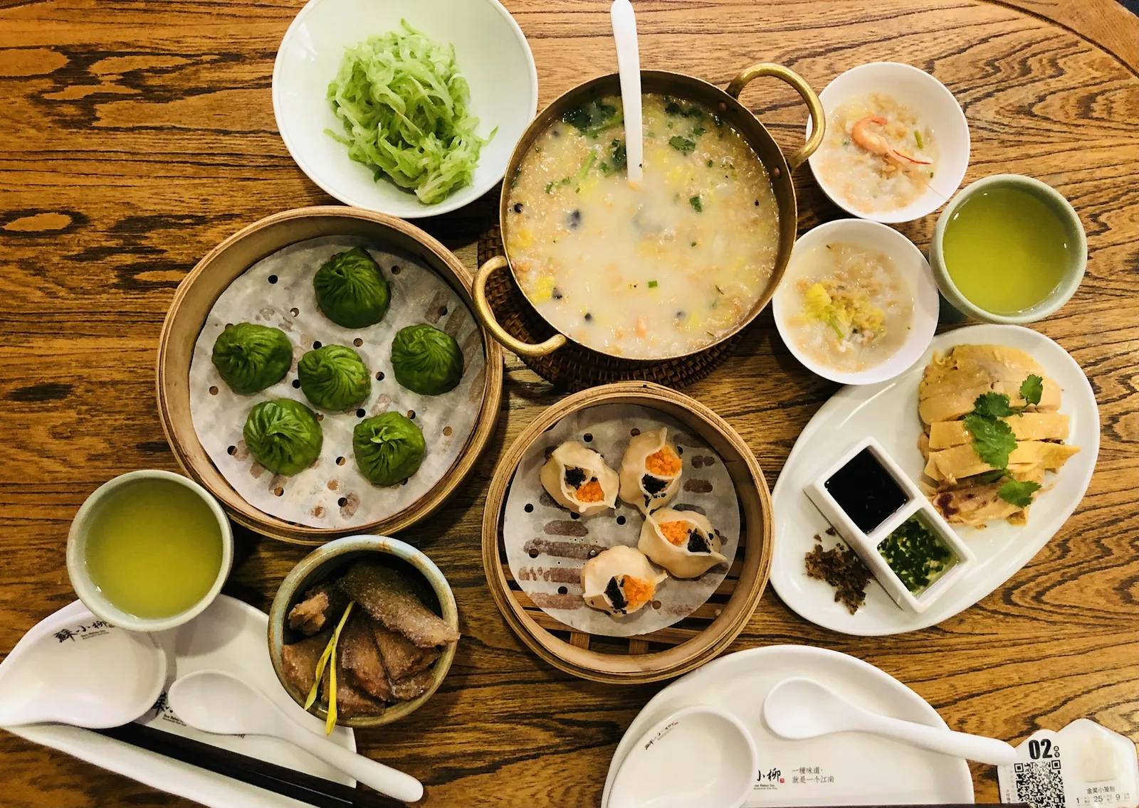 Overhead view of a Chinese meal spread across a wooden table