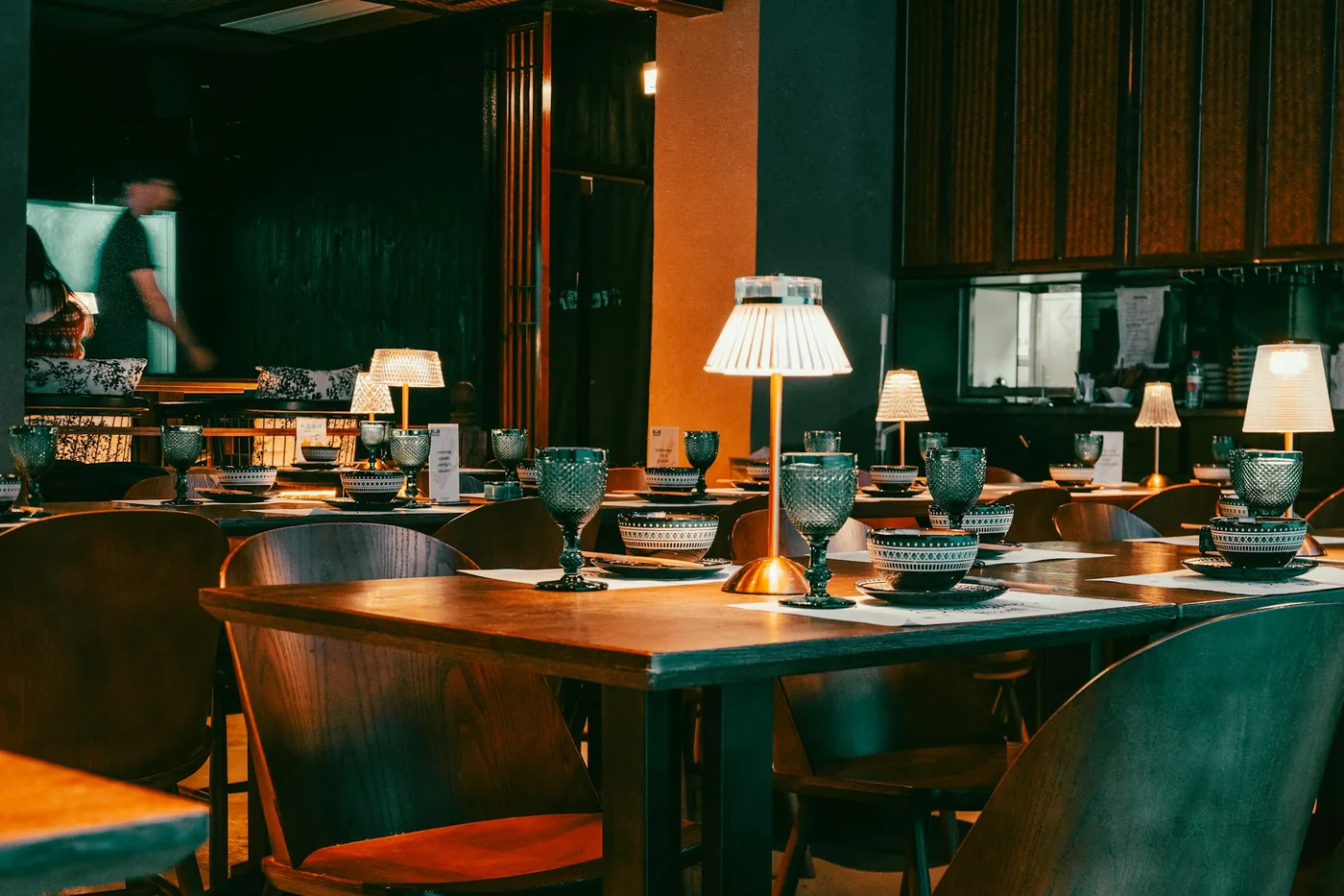 Warmly lit restaurant dining room in the evening