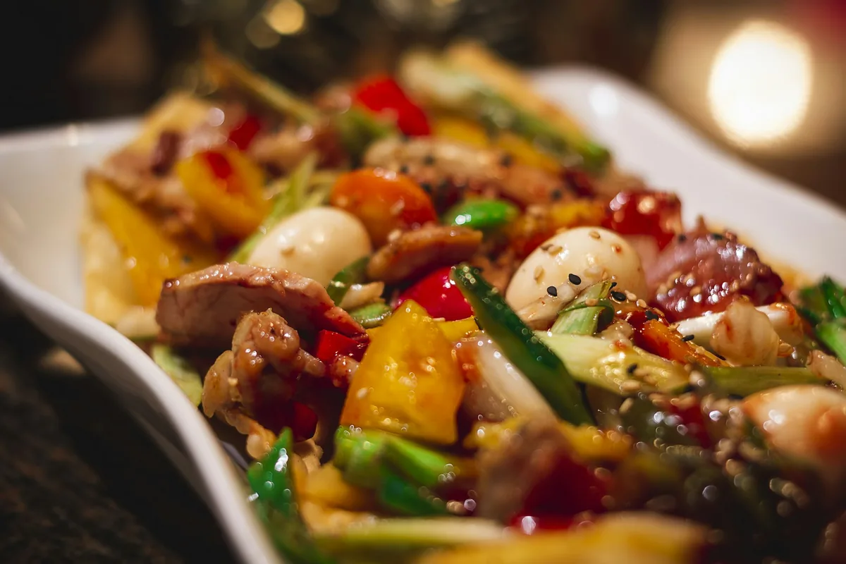 Mixed stir fry of shrimp, meat and vegetables on a serving dish